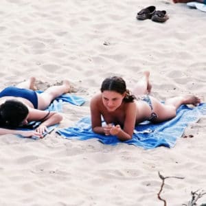 star Natalie Portman laying on a blue towel showing some cleavage