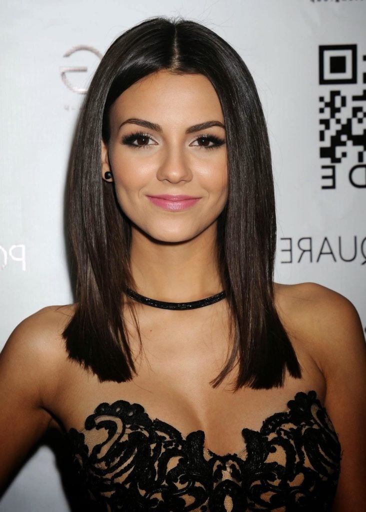 The singer Victoria Justice in black lacy dress wearing a choker 