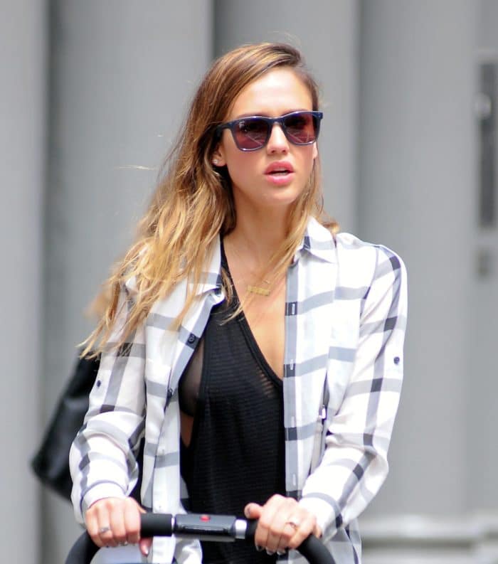 Actress Jessica Alba suffers a nipple slip in black tank top pushing a stroller