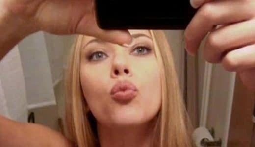 Scarlett Johansson taking a mirror selfie and making a kissy face