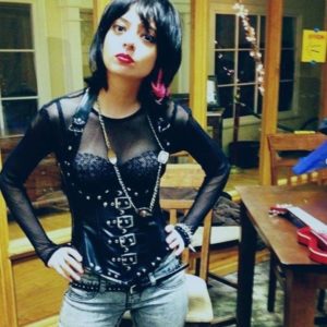 Kate Micucci in a mesh leather top and pink earings