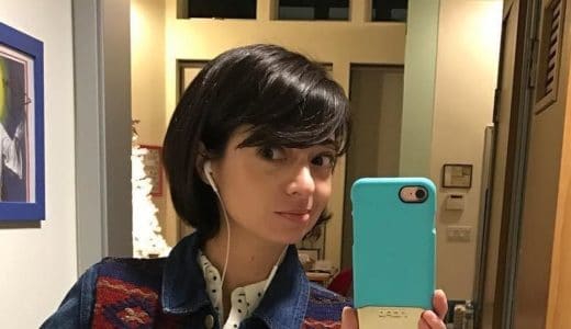 Kate Micucci taking a bathroom selfie in a jean jacket