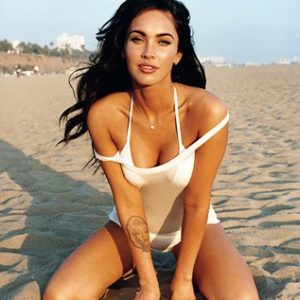 Megan Fox spreading her legs on the beach in white tank top