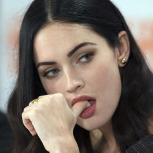 Megan Fox with finger in her mouth wearing red lipstick