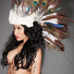 Nicki Minaj modeling topless with indian feathers on her head