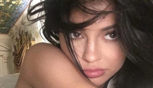 Kylie Jenner taking an up close selfie of her face with freckles visible