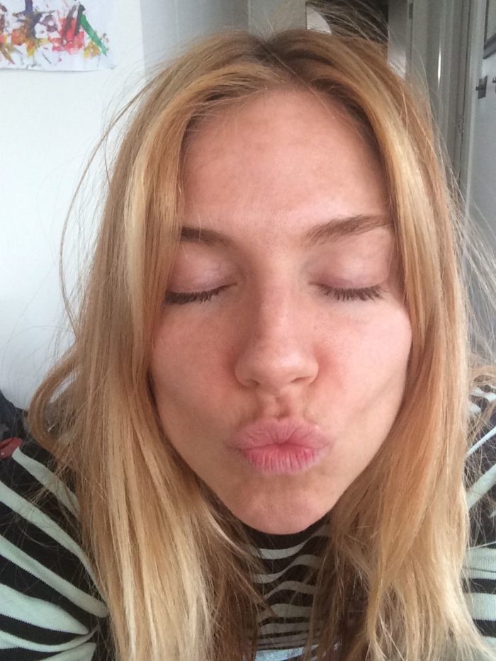Sienna Miller making a kissing face as she takes a selfie