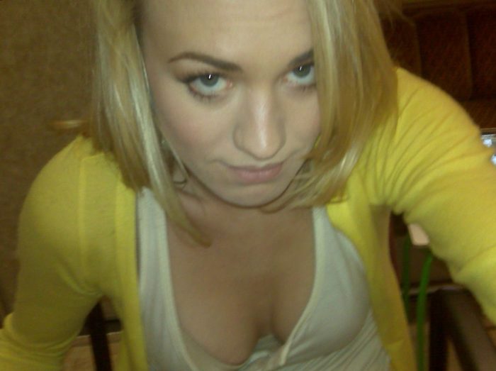 Yvonne Strahovski wearing a yellow top exposing cleavage