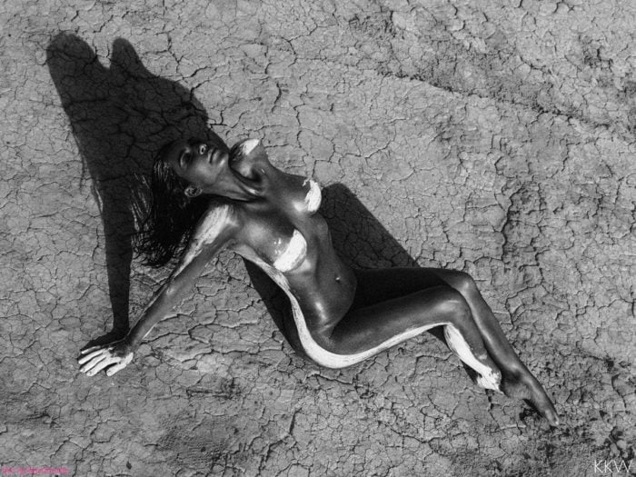 Black and white photo of Kim Kardashian naked in the desert