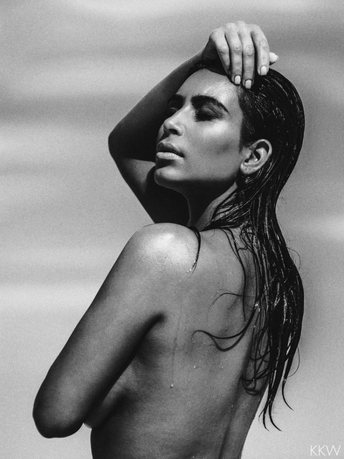 Kim Kardashian black and white photo of her modeling topless in the desert
