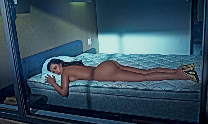 Kim Kardashian laying down naked on bed for Love magazine